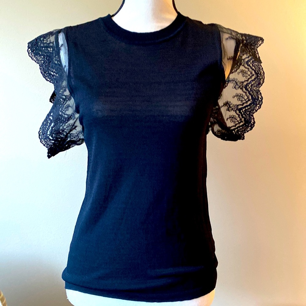 Light knitted blouse.  Great to wear alone or underneath a jacket.